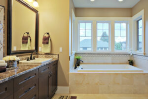 A beautiful, luxury bathroom with granite countertops and flooring